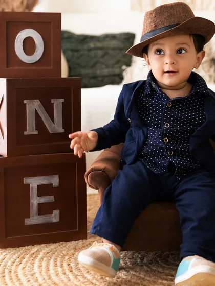 A dapper pre-birthday portrait in my studio, using classic props like 'ONE' blocks to create a timeless memory of this milestone.