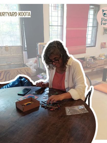 A participant enjoying a moment of solo puzzling at a Jigsaw Jam.