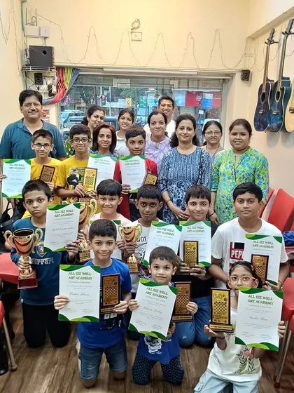 A proud group of chess tournament winners and participants with their families and instructors. What a great day for our chess community!