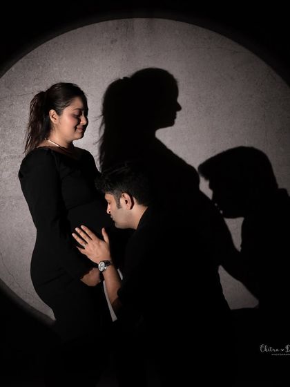 A creative use of shadow and light. The dad-to-be's silhouette kissing the bump adds another layer of love and storytelling to this artistic portrait.