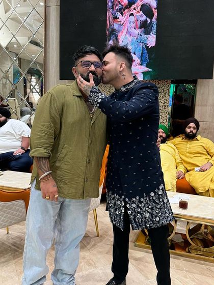 A fun moment between friends. Our client wears his navy blue Indo-Western jacket, a versatile piece for any celebration.