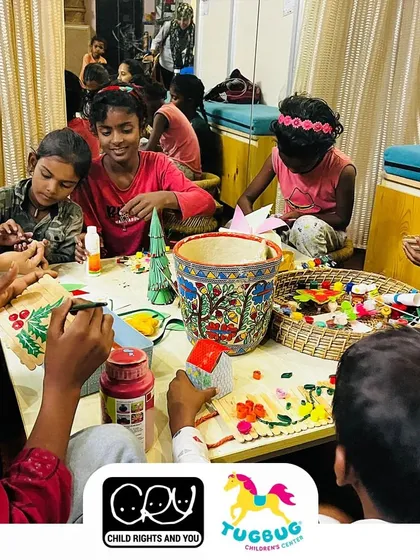 Children at a CRY activity center deeply engaged in a holiday-themed craft session. Art is a universal language of joy and expression.