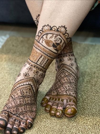 A side view of the peacock and grid foot design, showing how it elegantly adorns the ankle.