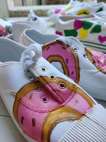 A detailed look at a donut-themed sneaker painted by a participant. I provide all the guidance and materials to help you turn a simple idea into a cool, wearable design.