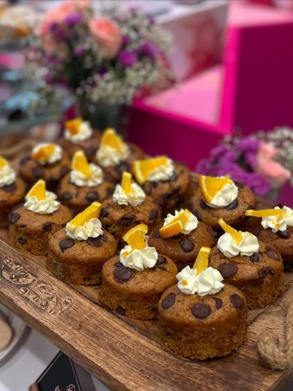 A close-up of our mini orange and chocolate chip tea cakes from the Nykaa event. Each one is individually garnished, showing the attention to detail we bring to our corporate event catering and dessert tables.