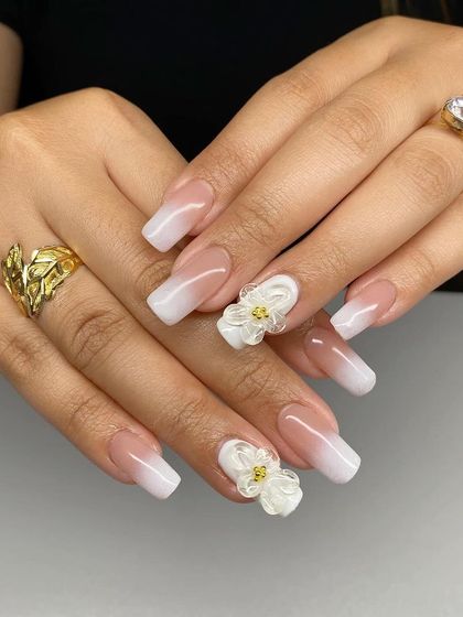 A beautiful white ombre set on square nails, with delicate 3D white flower accents.