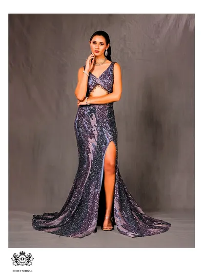 A confident pose in our shimmering two-piece gown. The high slit adds a modern, bold touch, making it a standout choice for a reception or cocktail event.