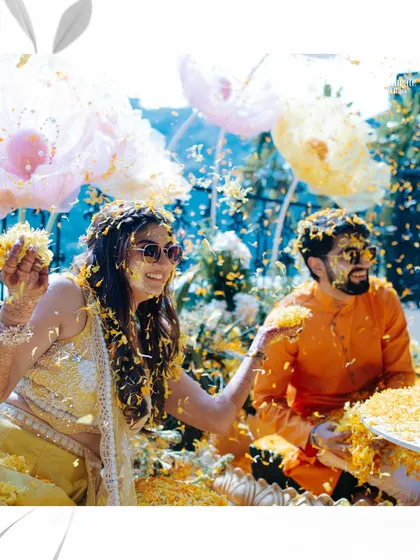 A playful flower fight between the bride and groom at their Haldi. These are the moments that show the friendship and fun at the heart of their relationship.