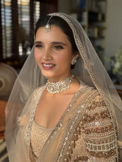 For this bride's Anand Karaj ceremony, we chose a soft, ethereal makeup look. The focus was on fresh, glowing skin and subtly defined eyes, perfectly matching the delicate pastel tones of her Tarun Tahiliani outfit. This is an example of minimal magic, enhancing natural beauty.