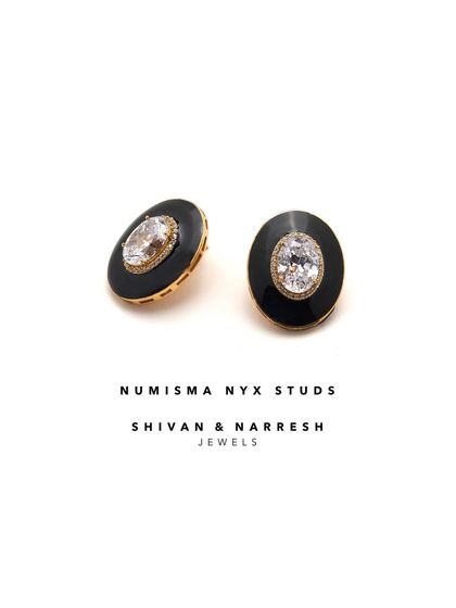 Understated yet unforgettable, the Numisma Nyx Studs by Shivan & Narresh are a modern ode to minimal luxury. The central zirconia stone is framed by chic black enamel.