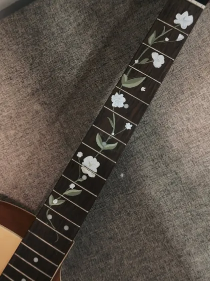 Another angle of the custom-painted guitar. Personalizing objects like this is a great way to make them truly your own.