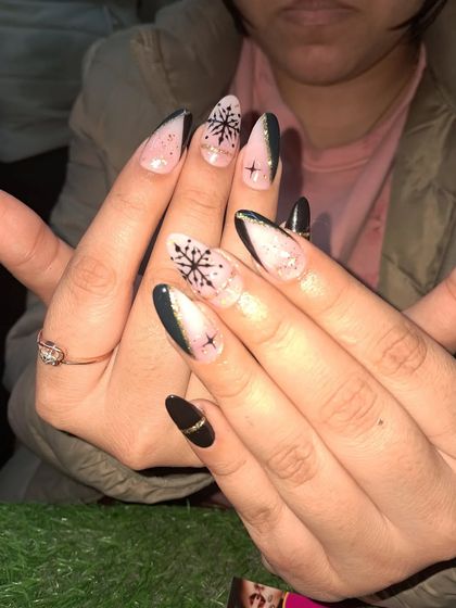 A festive winter-themed design with hand-painted black snowflakes on a shimmery pink base.