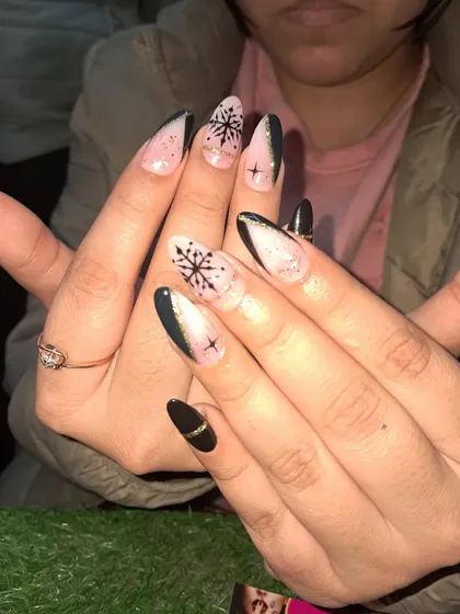 A festive winter-themed design with hand-painted black snowflakes on a shimmery pink base.