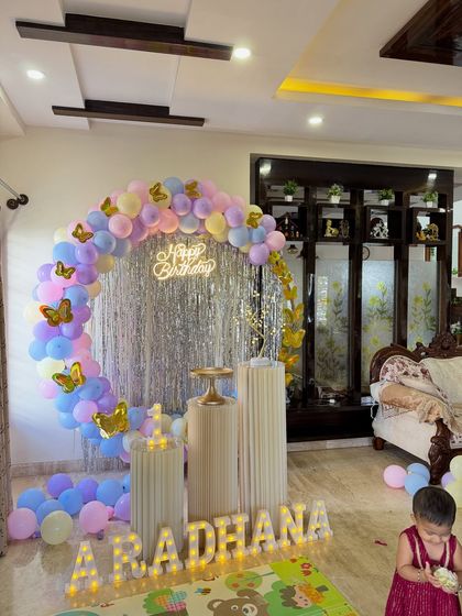 Another angle of the butterfly themed first birthday party, showing the arrangement of the pedestals and the light-up name. Every detail is placed to create a balanced and beautiful composition.