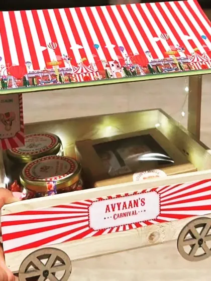 Custom party favors for 'Avyaan's Carnival'. We designed these adorable miniature carnival cart boxes filled with goodies, ensuring guests took a piece of the fun home with them.