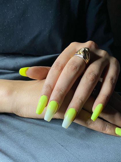 A bold and eye-catching neon yellow and white ombré on long coffin-shaped nails.