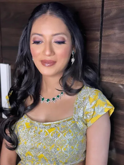 The focus here is on the glowing skin and the beautifully blended eye makeup. This is a perfect look for a Mehendi or Haldi ceremony.