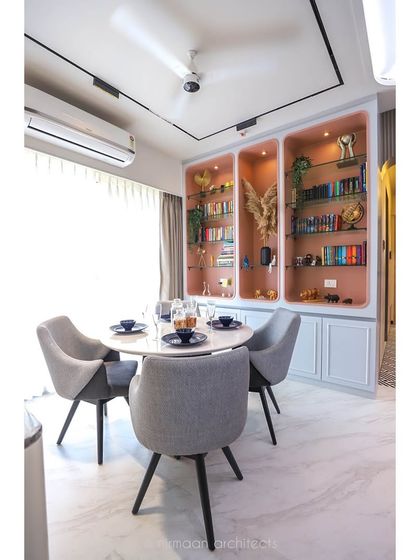 The dining area in the 'Atmosphere' project, with its custom-built display cabinet. This piece is not just for storage; it's a design feature that adds color and personality to the room.