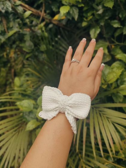 The crochet bow hair tie looks just as cute on your wrist as it does in your hair. It's a simple and stylish accessory for any occasion.