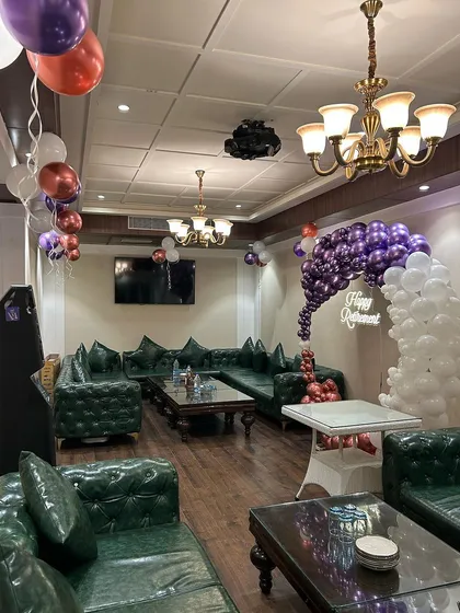 The lounge area of the retirement party, with balloon clusters adding to the festive atmosphere.