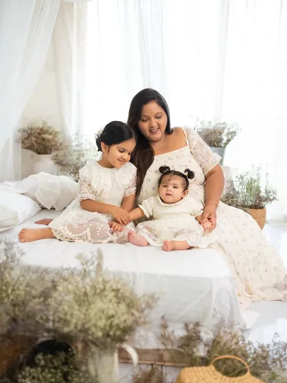 A mother with her two daughters in a beautiful, airy studio setting. The love between them is so evident.