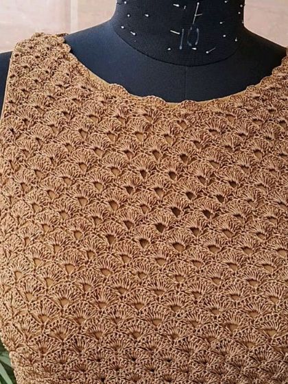 The delicate shell stitch detail on one of our custom-made blouses. We use premium yarns to ensure our apparel is not only beautiful but also soft and comfortable.