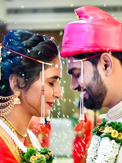 The sacred Akshata ceremony, a pivotal moment in a Marathi wedding. We capture the emotion as the couple showers each other with blessed rice, symbolizing prosperity and happiness.