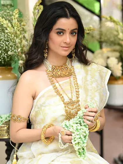 Another shot of Darshana Banik holding a 'gajra' (flower garland). This pose adds a classic and graceful element to the portrait, emphasizing the traditional theme.
