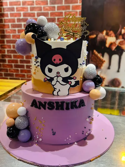 A trendy two-tier Kuromi cake in purple and orange, decorated with sparkling spheres.