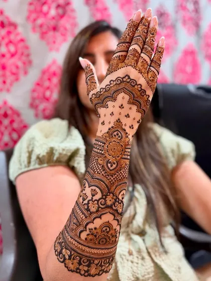 Another pose from the same happy client, showing off her intricate henna art.