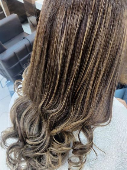 A close-up of a classic balayage, showing the hand-painted strokes that create a natural, blended highlight effect.