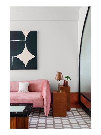 A full-height arched screen made of metal and glass separates the family lounge in our Ved House. This allows light and views to pass through while creating a distinct, multi-functional room with its own unique marble-mosaic-terrazzo floor.