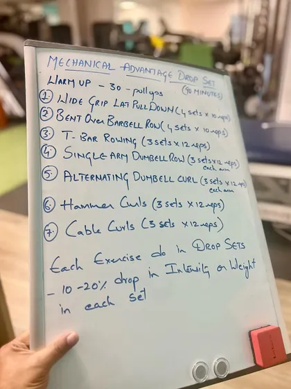 This is an example of a "Mechanical Advantage Drop Set" workout plan we design for clients. It details specific exercises like pull-downs and rows, showcasing the scientific and structured nature of our strength programs.