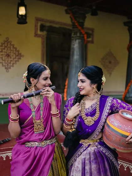 A playful portrait with one woman playing a flute, adding a musical and joyful element to this traditional photoshoot.