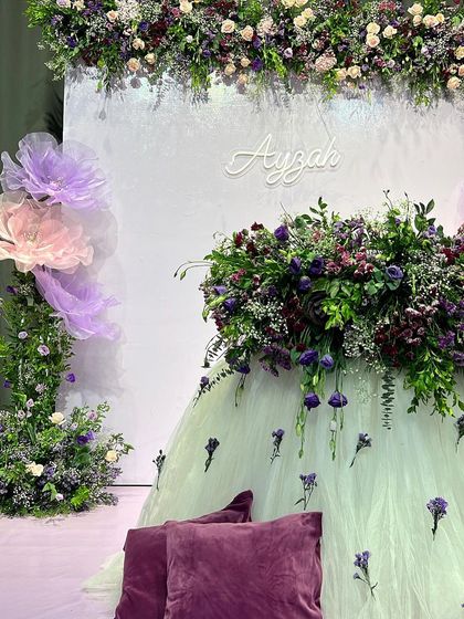 A close-up of the stunning floral table created for Ayzah's cradle ceremony. The combination of fresh flowers and a soft tulle skirt creates a dreamy and ethereal effect.