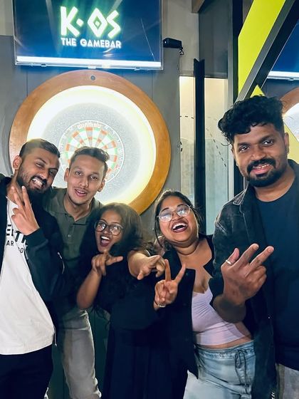 Friends posing with peace signs, fully embracing the fun and chaotic energy of our Thursday night karaoke.
