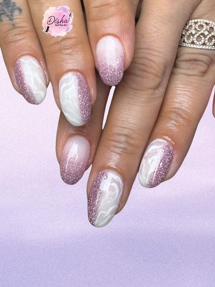Pink glitter ombre nails with soft white marble swirls. This set is the perfect blend of glam and grace.