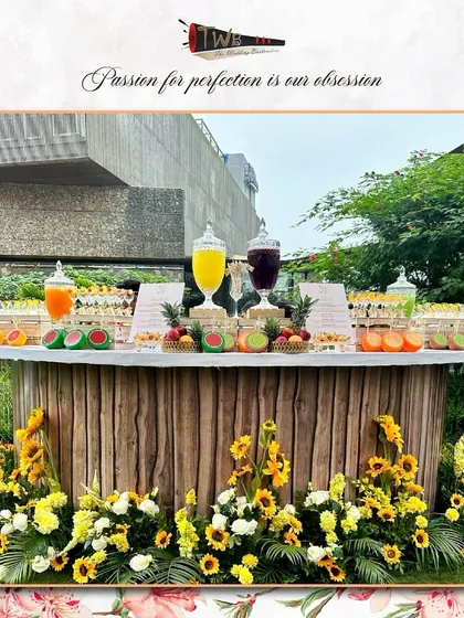 A bright and sunny brunch bar decorated with sunflowers and fresh fruits. This setup is perfect for daytime events, offering a refreshing and visually appealing station for guests to enjoy.
