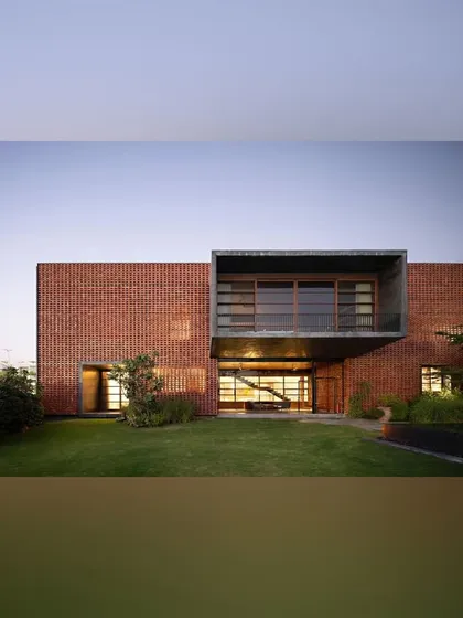The rear view of the Ishtika house opens onto a manicured lawn. The design features a dramatic cantilevered box, and our landscape plan provides an open, green expanse that complements the home's strong architectural forms.