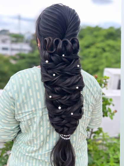 A side view of the complex looped braid, showing the volume and artistry involved in its creation.