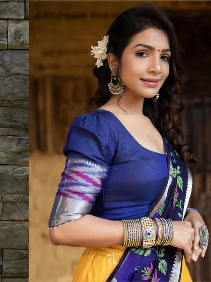 A striking half saree combination of mustard yellow and navy blue. The blouse features modern puff sleeves with a traditional border, creating a unique fusion look.