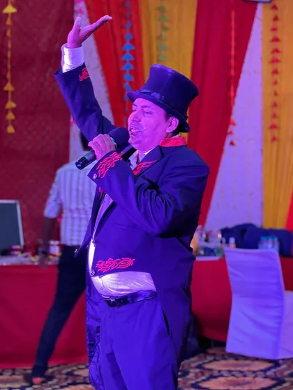 Commanding the stage with a microphone in hand. A big part of my performance is storytelling and comedy, which helps connect with the audience and build anticipation for the tricks.