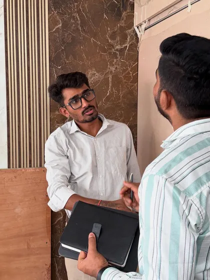 A discussion with my team member on-site, planning the installation of decorative wall panels.