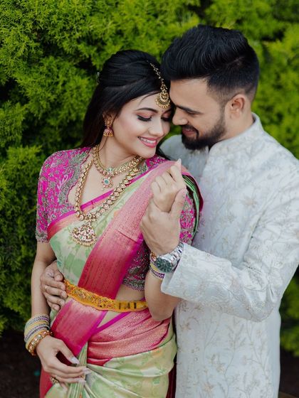A sweet moment between the couple. The bride's traditional look is perfectly complemented by the groom's simple and elegant attire.