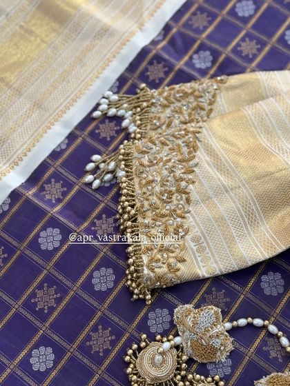 A close-up of the sleeve cuff with pearl and zardosi work.