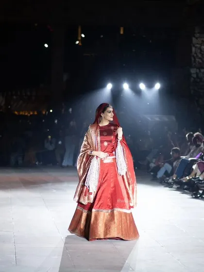 Another angle of Kriti Sanon on the runway, showing her interacting with the audience. This captures the live, engaging nature of a fashion event.