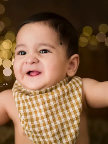 That pure, uncontainable joy. This is the kind of smile that lights up a room, and it's my absolute favorite thing to capture during a milestone baby photography session. A close-up portrait like this freezes a moment of pure happiness.