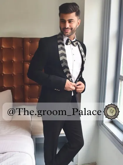 A client looking stylish in our black tuxedo with a chevron-patterned lapel and bow tie. It's a modern twist on a classic, perfect for making a subtle statement.