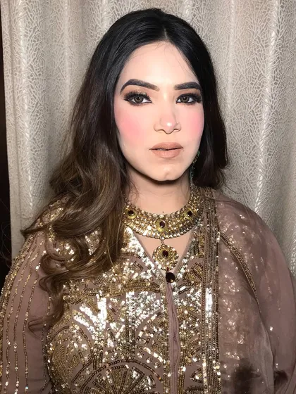 A full shot of the client in her nude and gold outfit, her choker adding a touch of royalty.