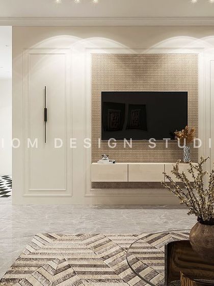 A floating media unit is set against a wall with classic panel molding. This blend of modern furniture and traditional architectural details is key to our contemporary neoclassical style.